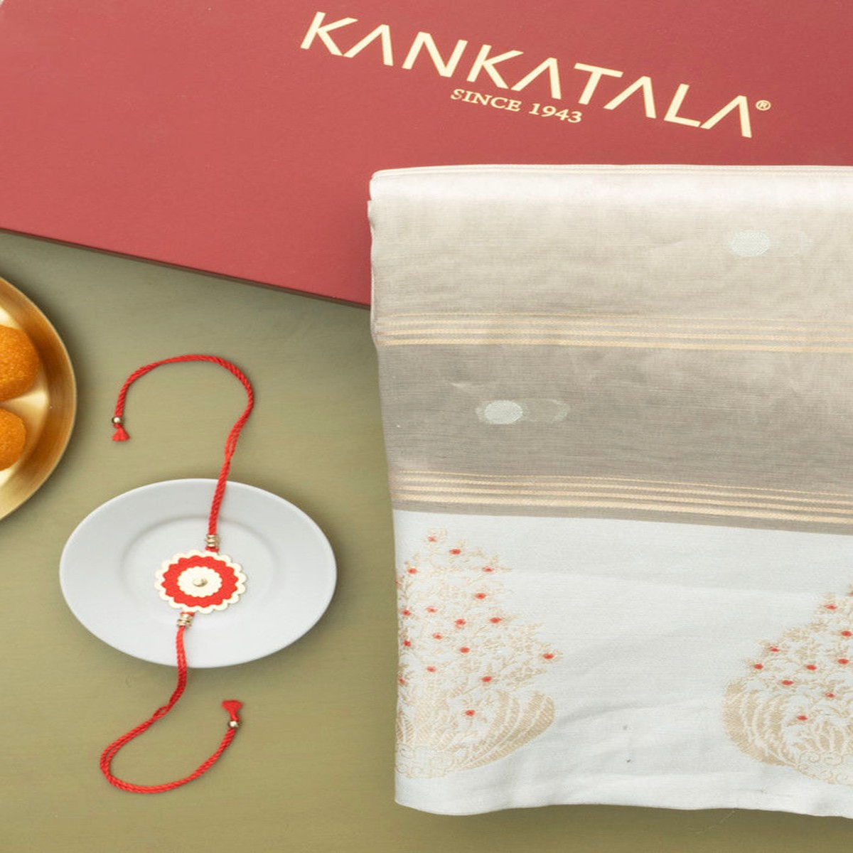 kanchipuram-kora-organza-tissue-brocade-gold-saree-with-satin-border-and-rakhi
