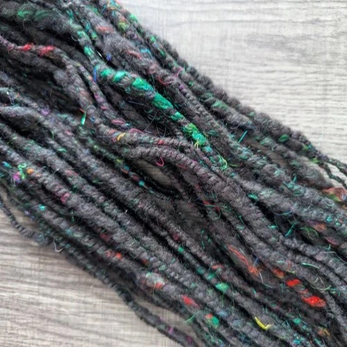 handspun-art-yarn-dark-fantasy-goth-black-red-green-wool-silk-firestar-32yd-1oz